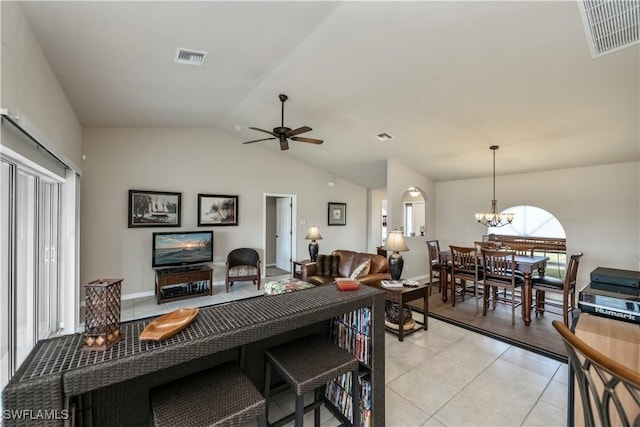 living room with light tile patterned floors, ceiling fan with notable chandelier, lofted ceiling, and visible vents