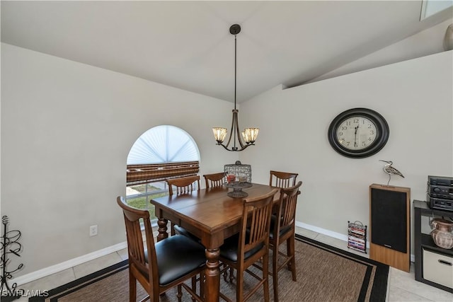 dining area featuring lofted ceiling, light tile patterned floors, and a notable chandelier