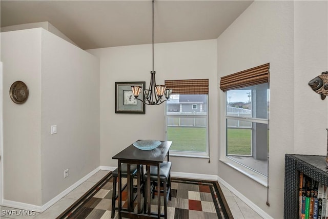 tiled dining area with a chandelier