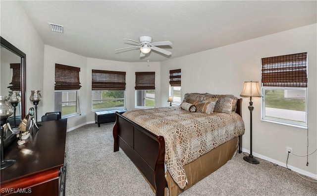 bedroom with carpet floors, baseboards, visible vents, and a ceiling fan