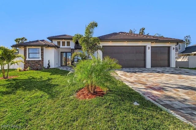 view of front facade with a garage and a front yard