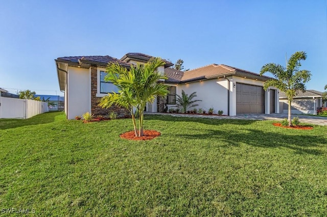 view of front of house with a garage and a front lawn