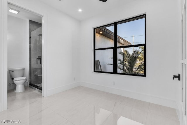 bathroom featuring walk in shower and toilet