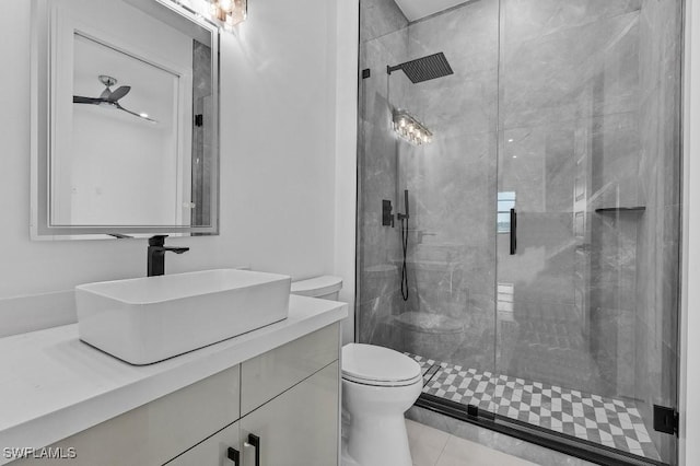 bathroom featuring tiled shower, vanity, and toilet