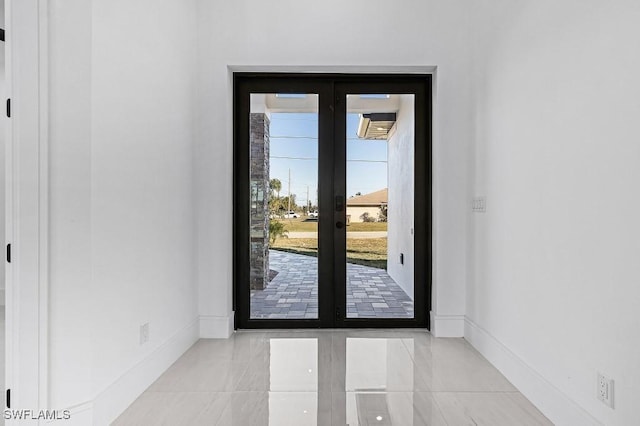 doorway with light tile patterned floors and french doors