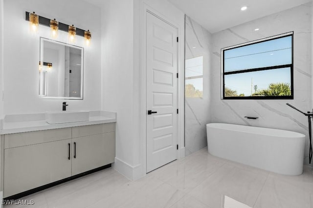 bathroom featuring vanity and a tub