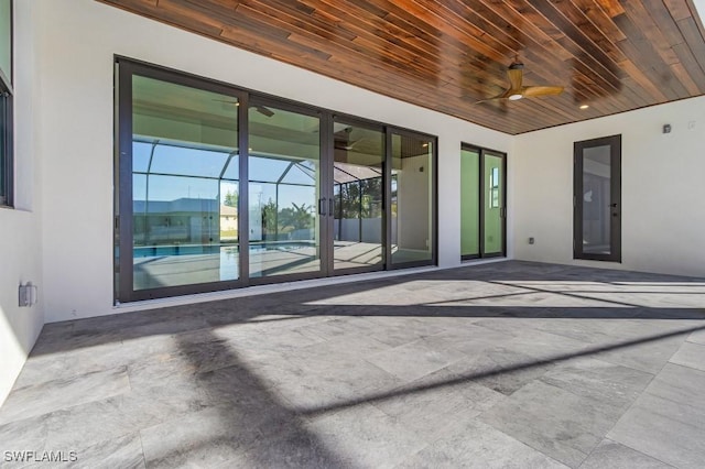 view of patio featuring a lanai and ceiling fan