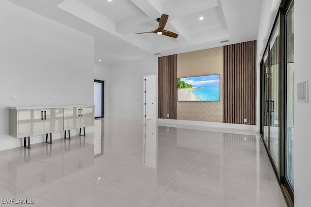 empty room with coffered ceiling, beamed ceiling, and ceiling fan