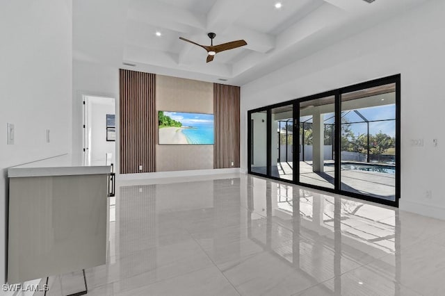 unfurnished living room with ceiling fan, coffered ceiling, and beam ceiling