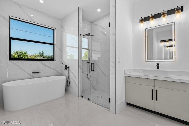 bathroom with vanity and separate shower and tub