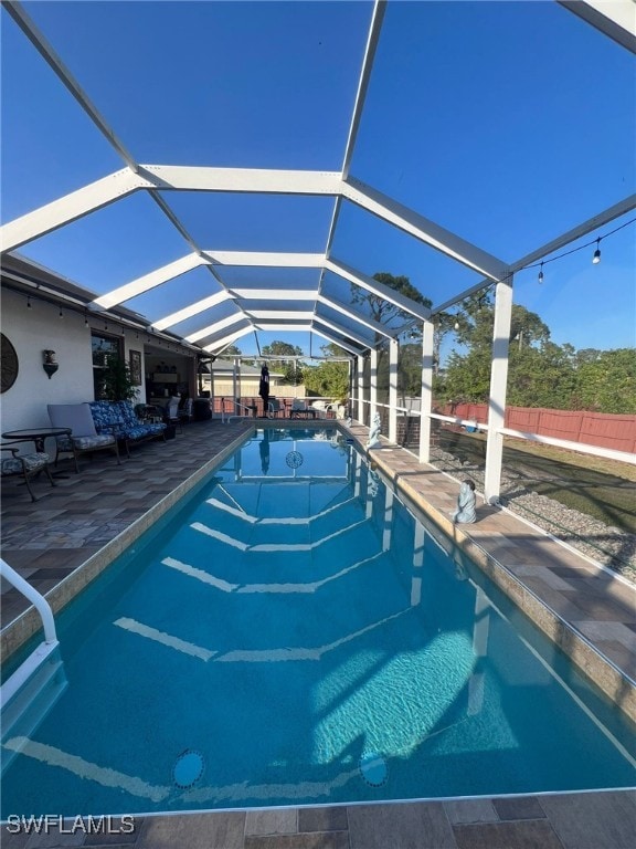 view of swimming pool with a lanai and a patio