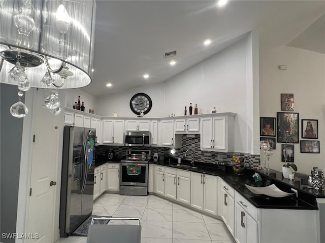 kitchen with sink, decorative light fixtures, white cabinets, and appliances with stainless steel finishes