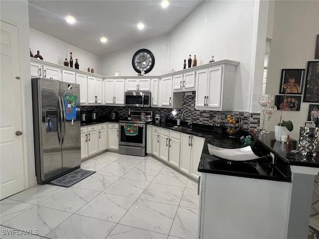 kitchen featuring tasteful backsplash, white cabinets, and appliances with stainless steel finishes