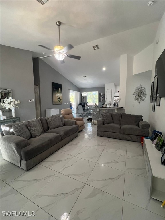 living room featuring ceiling fan with notable chandelier and high vaulted ceiling