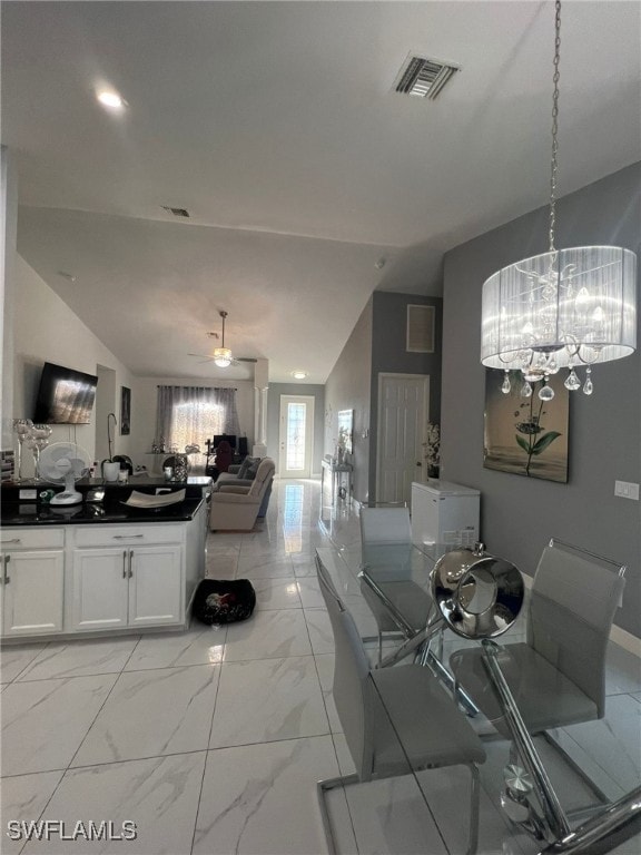 dining space featuring vaulted ceiling and ceiling fan