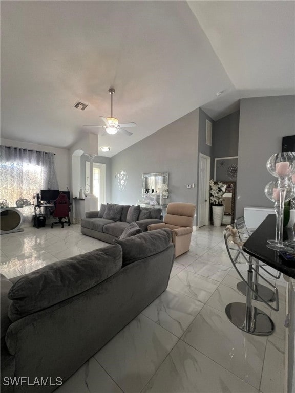 living room featuring vaulted ceiling and ceiling fan