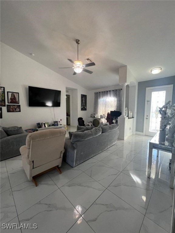 living room with vaulted ceiling, ceiling fan, and decorative columns