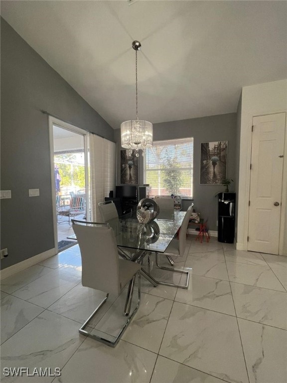 unfurnished dining area featuring vaulted ceiling, a healthy amount of sunlight, and a chandelier