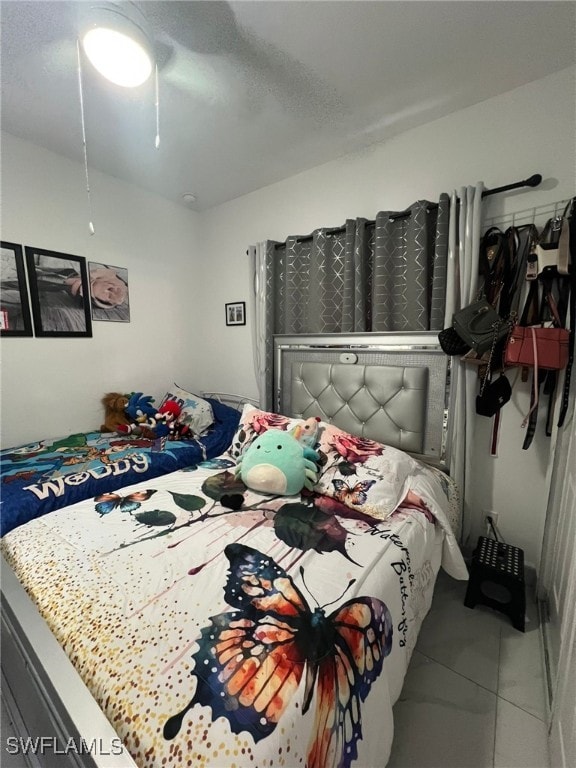 bedroom with tile patterned flooring and ceiling fan