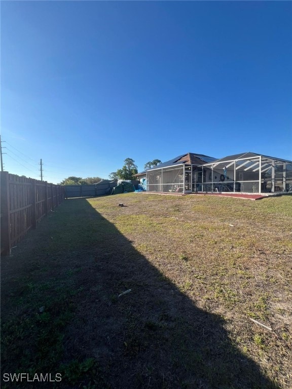 view of yard with glass enclosure