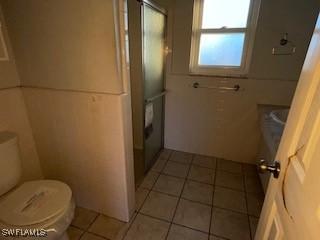 bathroom with tile patterned floors and toilet