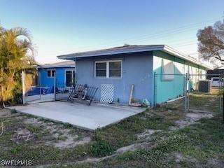 rear view of property with central AC and a patio area