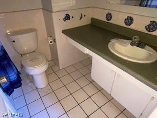 bathroom with vanity, toilet, and tile patterned flooring