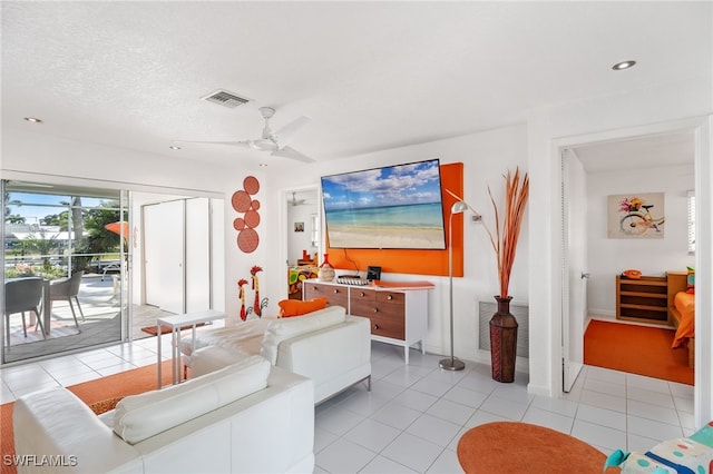 tiled living room featuring a textured ceiling and ceiling fan