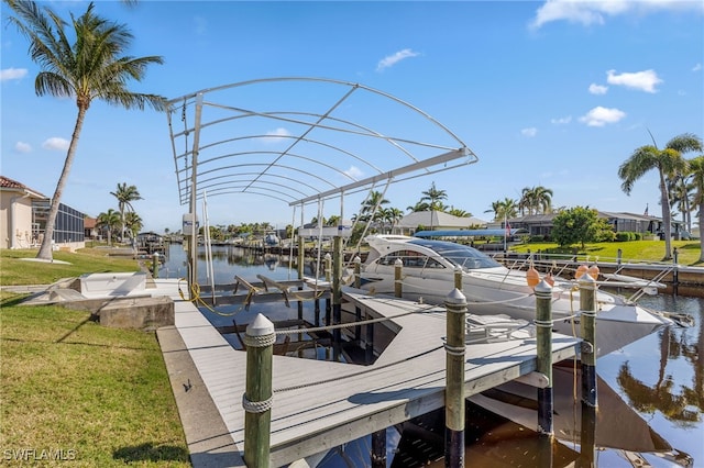 view of dock featuring a water view and a yard