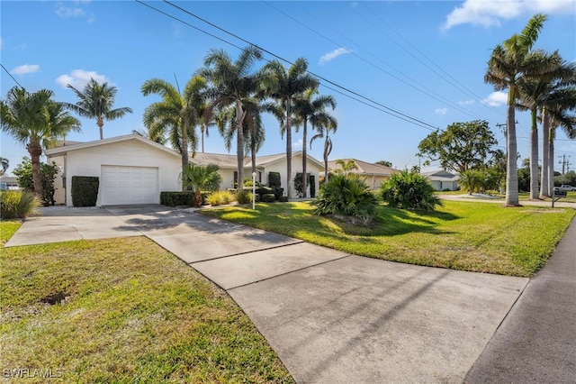 view of front of house featuring a garage and a front lawn