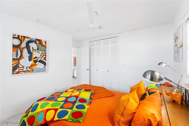 bedroom with ceiling fan and a closet