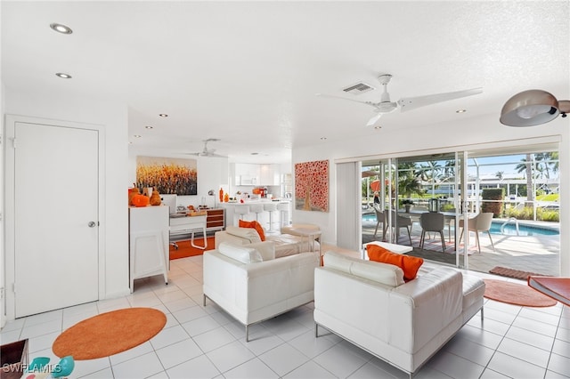 living room featuring ceiling fan and light tile patterned floors