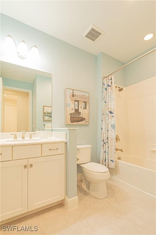 full bathroom with vanity, toilet, tile patterned flooring, and shower / bath combo with shower curtain