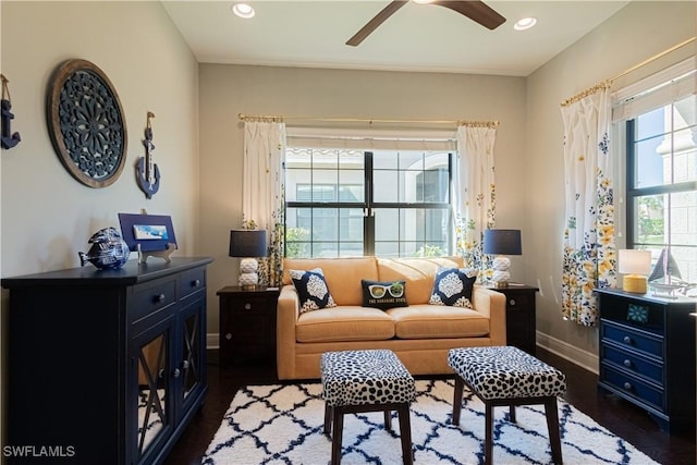 living room featuring ceiling fan and dark hardwood / wood-style flooring