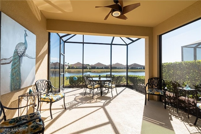 sunroom / solarium featuring a water view