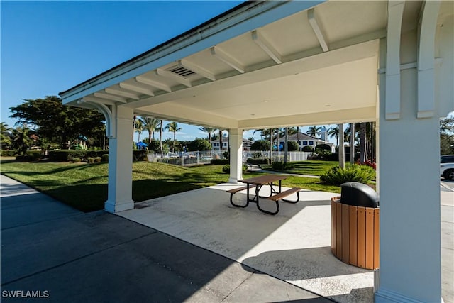 view of community featuring a patio area and a lawn