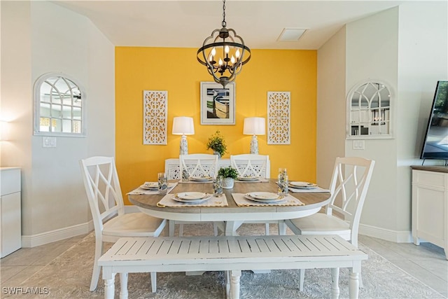 dining space with an inviting chandelier and light tile patterned floors