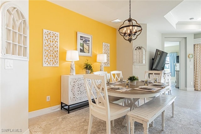 tiled dining room with ornamental molding and a chandelier