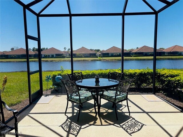 unfurnished sunroom featuring a water view and plenty of natural light