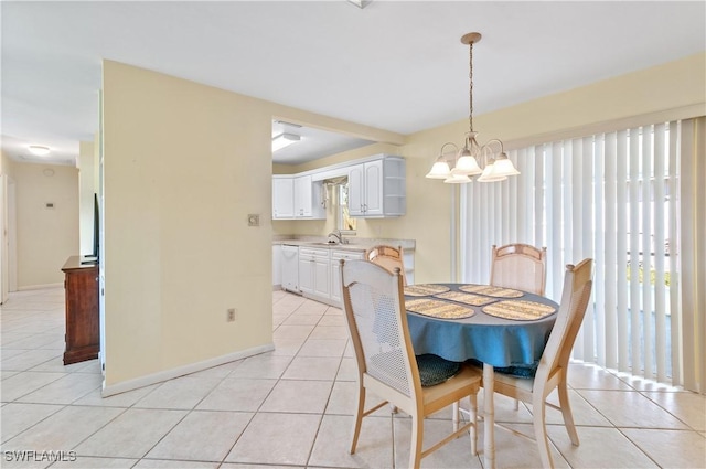 tiled dining room with sink and an inviting chandelier