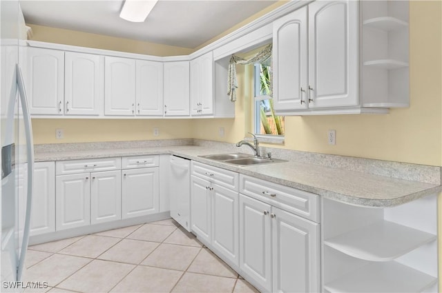 kitchen with white cabinetry, sink, refrigerator with ice dispenser, and light tile patterned floors