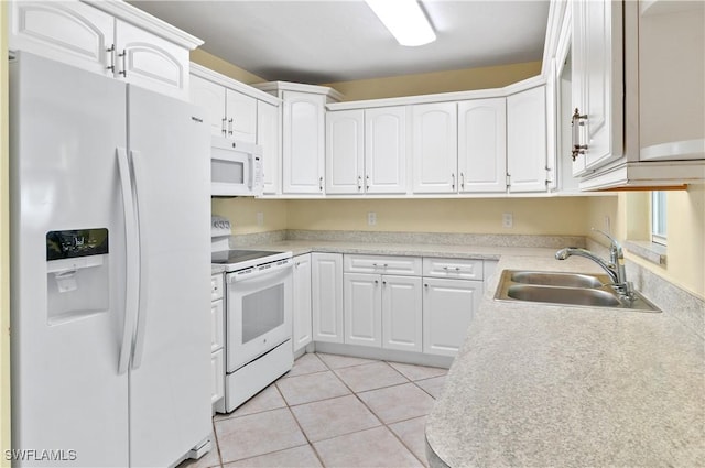 kitchen featuring sink, white appliances, light tile patterned floors, and white cabinets