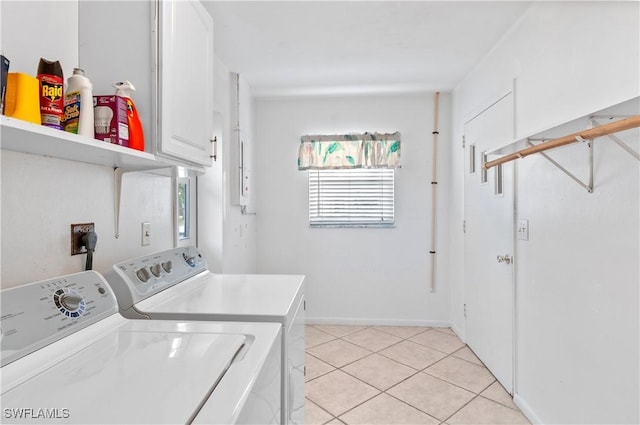 laundry area featuring cabinets, separate washer and dryer, and light tile patterned floors