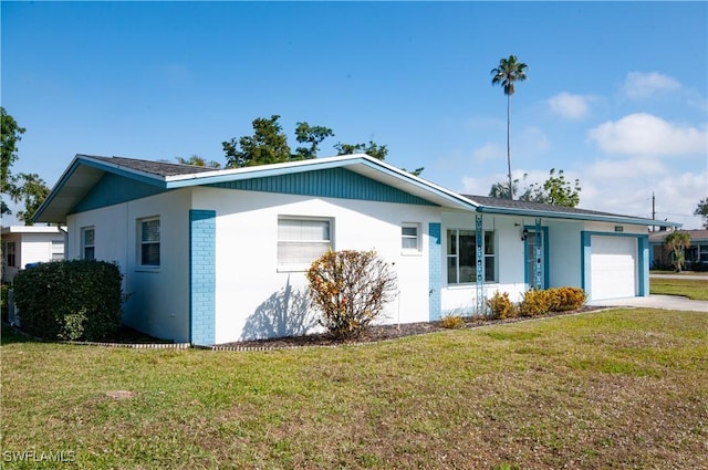 ranch-style house featuring a garage and a front lawn