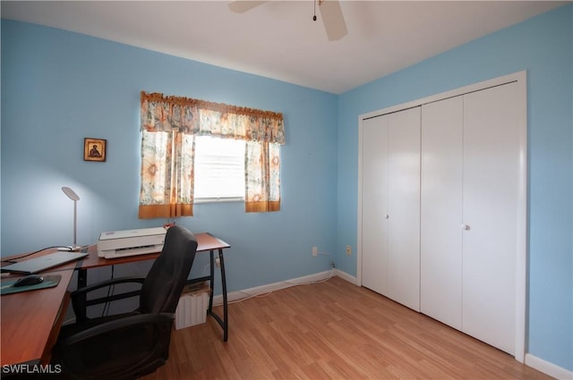 office with light hardwood / wood-style floors and ceiling fan