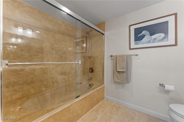 full bathroom with toilet, baseboards, bath / shower combo with glass door, and tile patterned floors