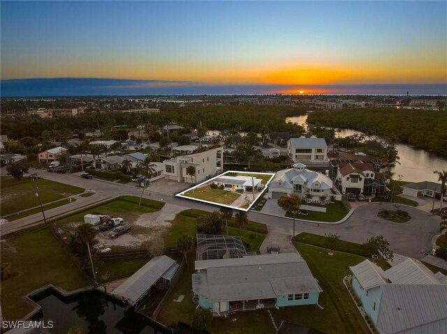 aerial view at dusk with a water view