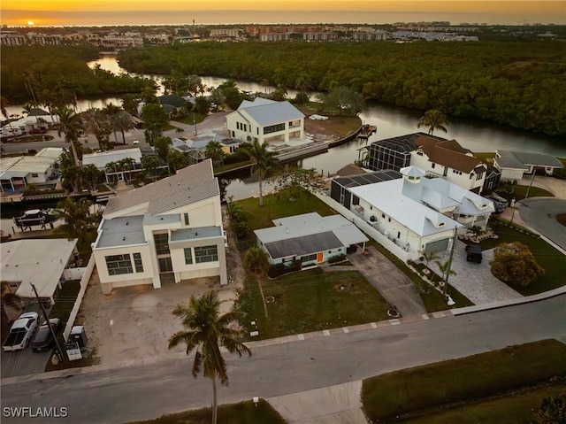 aerial view at dusk with a water view