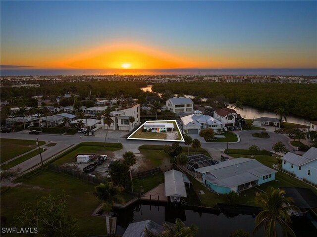 aerial view at dusk with a water view