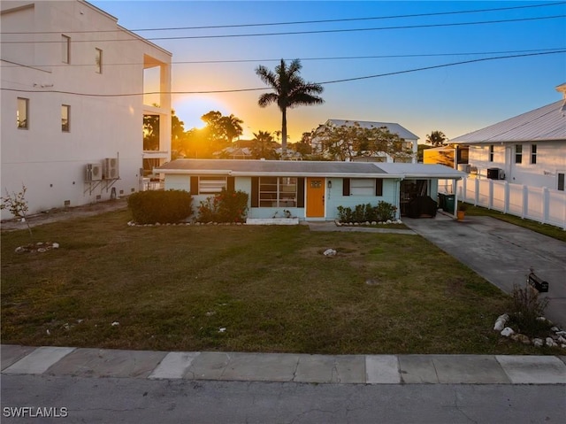 view of front facade with a yard and a carport